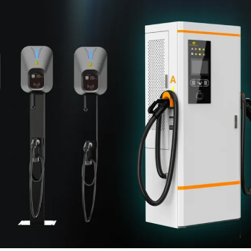 Two electric vehicle charging stations next to a white and orange electric charger unit with cables and digital display.